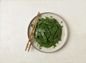 Salad of young peas, in pods, with sesame seeds, asian cuisine, homemade