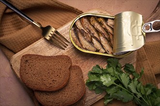 Preserves, sprats with black bread, top view, no people