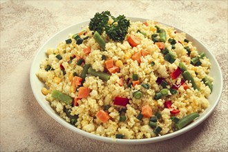 Couscous with vegetables, paprika, carrots, string beans, corn, homemade, top view, no people