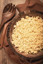 Cooked couscous, in a wooden bowl, top view, no people