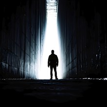 Silhouette of a man at a tunnels entrance with a stark contrast, AI generated