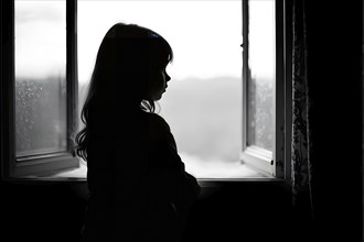 Young girl lost in the realm looking out of a weathered window as symbol for loneliness, AI