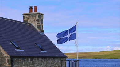 Shetland Flag waving on a typical medieval house in Lerwick downtown and port in Scotland, England,