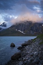 Mountain landscape on the Lofoten Islands. View over the sea to a mountain, the summit is in the