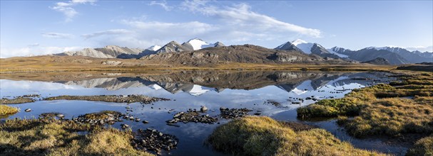 Glaciated mountain peaks reflected in a mountain lake at sunset, Arabel Lake at Arabel Pass, Issyk