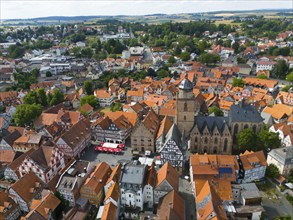 Aerial view of a picturesque historic town centre with many half-timbered houses and a large