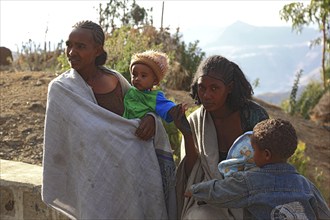 In the highlands between Mekele and Lalibela, mother with children in her arms, Ethiopia, Africa