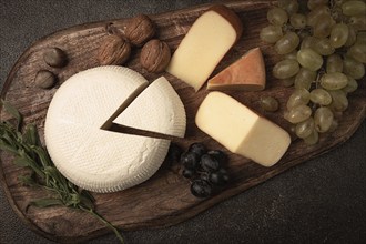 Georgian cheese, Imeretian and smoked suluguni, grapes, nuts, on a cutting board, Georgian cuisine,