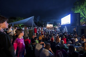 Visitors watch the football match at the Adidas fan zone at the Bundestag during the final match