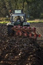 Farmer ploughing a field, tractor with plough, near Neuss, North Rhine-Westphalia, Germany, Europe