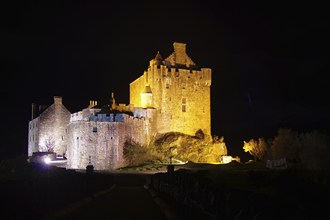 Impressive medieval castle illuminated at night, with festive atmosphere, Highlander, Braveheart,