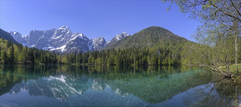 Mangart mountain range reflected in the lower Fusine Lake, Tarvisio, province of Udine, Italy,