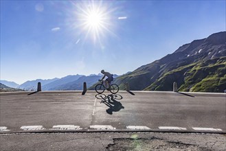 Furka Pass. A challenge for ambitious cyclists. Backlight with sun star. Realp, Canton Uri,