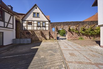 Historic town fortification with town gate under a cloudless blue sky at the Untere Pfarrgasse in