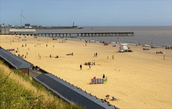 View over roofs of beach huts to Claremont Pier, South Beach, Lowestoft, Suffolk, England, UK