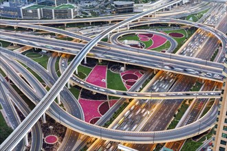 Intersection of Sheikh Zayed Road traffic on the road near the Burj Khalifa with Metro in Dubai,