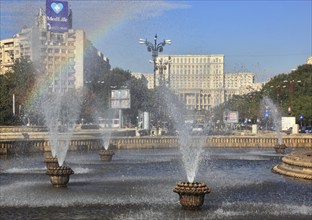 City centre, fountains and skyscrapers at Bulevardul Unirii, behind the Palace of Parliament,