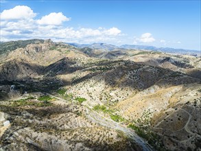 Mountains and Olive groves around Ghost Town from a drone, Pentedattilo Village, Calabria, Italy,