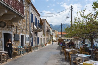 Mediterranean street with cafés and restaurants on a sunny coast, Agios Nikolaos, Mani, Messenia,