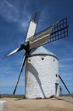 White windmill in a rural area with clear sky and few clouds, Consuegra, Toledo, Castilla-La