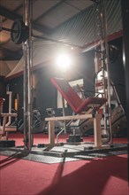 Red weight bench in an empty training room under lighting, Historic Fitness Studio, Bulls Fit,