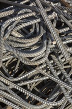 Pile of construction grade steel rods in metal recycling yard, Quebec, Canada, North America