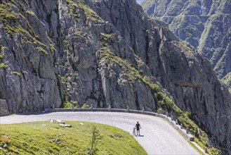 Cyclists on the road on La Tremola, the world-famous Alpine pass through the Val Tremolo,