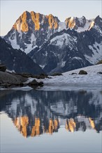 Morning atmosphere, mountain landscape at sunrise, reflection in Lac Blanc, mountain peak Grandes