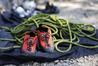 Special climbing shoes and a dynamic rope are part of the equipment for sport climbers on the rock.