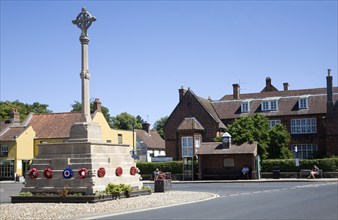 War memorial and historic buildings in the town of Holt, north Norfolk, England, United Kingdom,