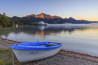 Boat on the shore, mountains reflected in the lake, summer, morning light, silence, Lake Kochel,