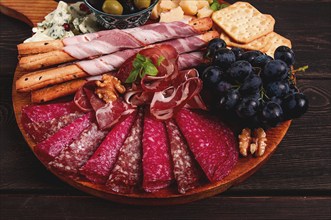 Appetizer, assortment, set, sausage, and cheese, on a wooden board, top view, no people