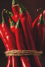 Bunch of red hot chili pepper, close-up, on a dark background, selective focus, no people, concept,