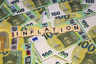 Symbolic image of inflation: letters on euro notes show the word inflation