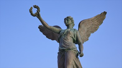 Statue of an angel with outspread wings in front of a blue sky, harbour area, Rhodes Town, Rhodes,