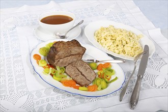 Swabian cuisine, roast beef, roast ox, herb spaetzle, meat dish, gravy, carrot vegetables, leek,