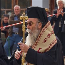 Archbishop Amphilochios, priest in elaborate religious dress gives a speech to a crowd, visit of