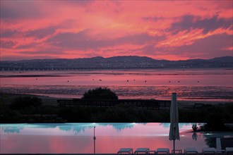 Sunset over the Tagus estuary reflecting in a pool, Lisbon, Portugal, Europe