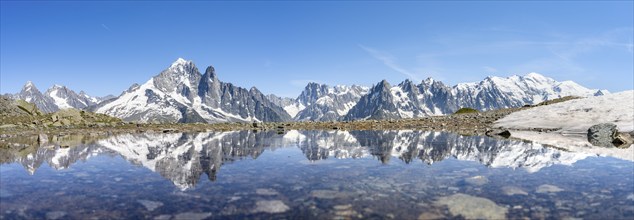 Mountain landscape, reflection in a small mountain lake, mountain peaks Aiguille Verte, Grandes