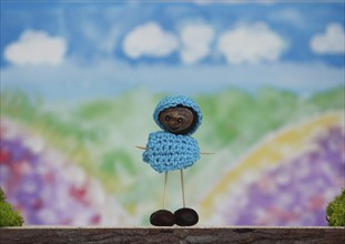 Chestnut figure with hat and jumper in the studio