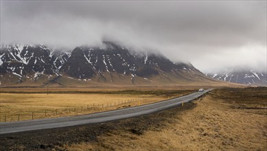 Highway countryside straight empty road leading to the snowy mountains at snaefellsnes peninsula in