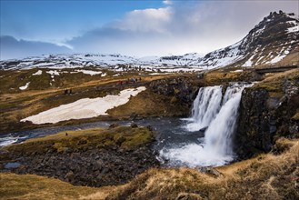 The Kirkjufell mountain and the kirkjufellfoss waterfall at grundarfjordur at Snaefellsnes