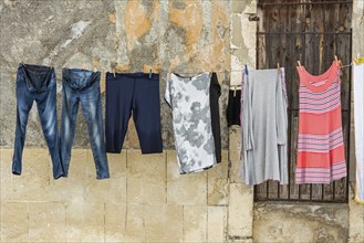 Clothesline with fresh laundry in front of old Italian town house