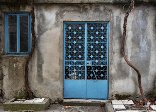 Closed metal blue vintage door. Traditional cyprus doors with decorations. House entrance. Deserted