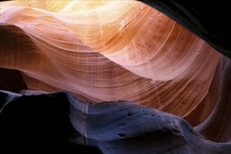 Beam of light on a colourful rock face