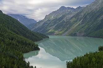 Reflection of mountains in the lake. Kucherla lake. Altai Mountains, Russia. Overcast summer