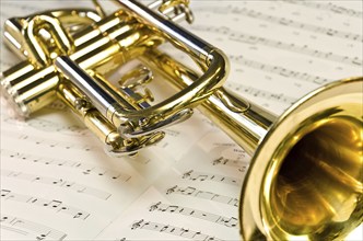 Golden trumpet lying on sheet music