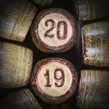 Wooden vintage lotto kegs with two numbers 20 and 19 as symbol of 2019 year. Close-up top view of