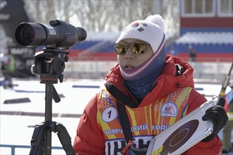 Coach of South Korea biathlon team instructs biathletes at shooting range of biathlon stadium