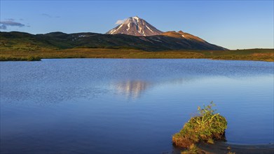 Stunning panorama autumn volcano landscape of Kamchatka Peninsula at sunset: scenery evening view